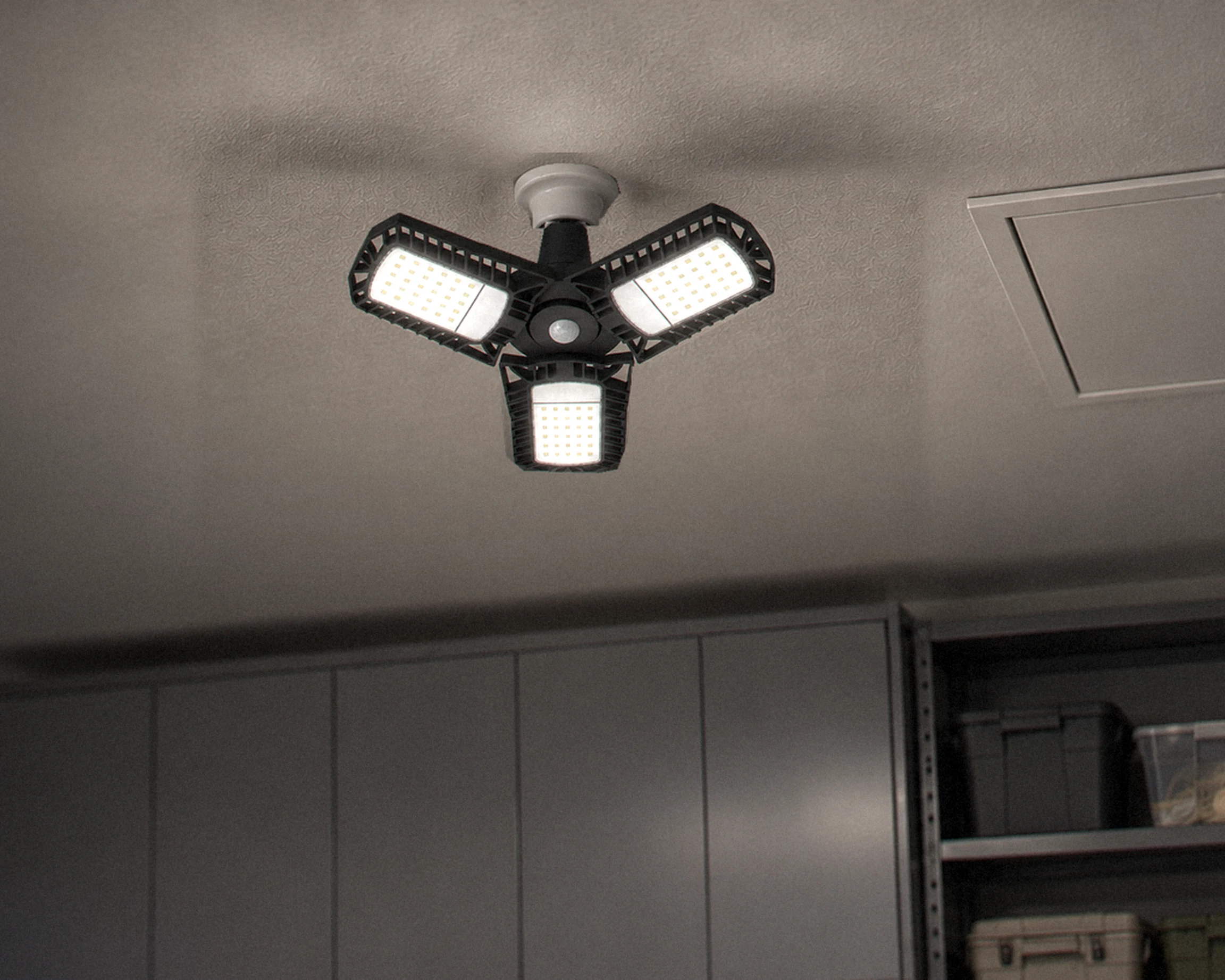Zone Motion-activated 3-panel garage light, shown in a typical installation (illustration)